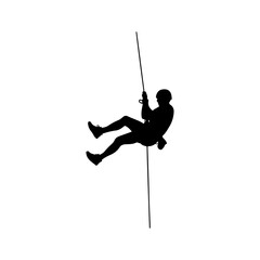 Silhouette of a person rappelling down a rope.