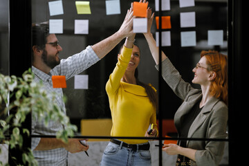 Team brainstorming session with sticky notes in a modern office environment during the afternoon