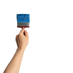 Hand holding a blue-bristled paint brush, appearing to apply paint to a black background