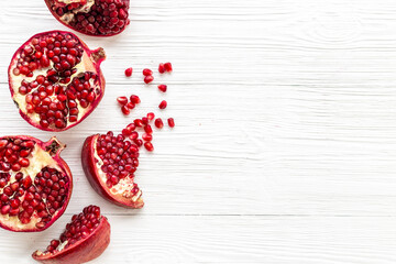 Top view of fresh ripe pomegranate with half and pieces ready for eating