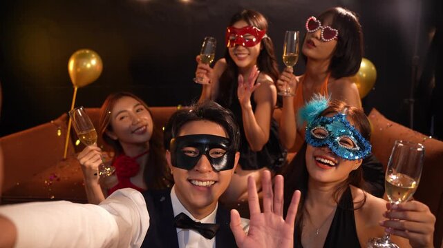 Beautiful woman having fun with group of friends clinking champagne glasses during celebration party. Drink concept.