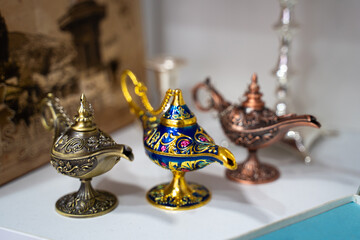 A collection of ornate genie lamps in various colors and designs. perfect for adding a touch of whimsy to home interiors or as unique gift ideas.