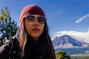 Woman hiking mountain with popocatepetl volcano in mexico