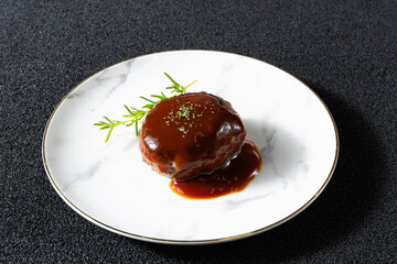白い皿に盛り付けたデミグラスハンバーグ Demi-glace hamburger steak served on a white plate