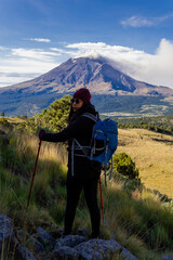 Woman hiking iztaccihuatl volcano with popocatepetl in background mexico