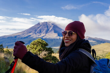 Woman hiking iztaccihuatl volcano with popocatepetl in background