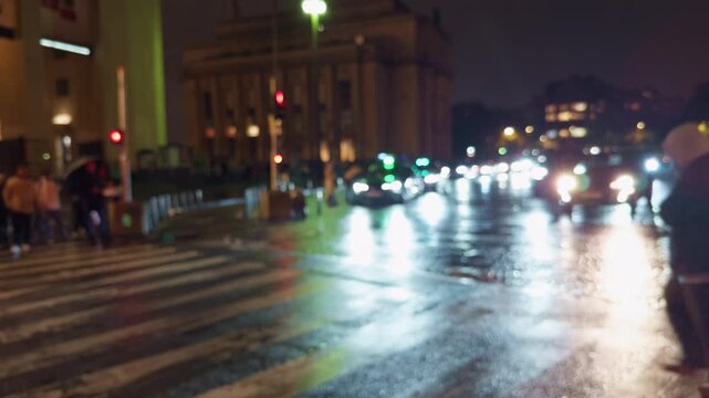 A captivating nighttime city scene showcasing bustling traffic and beautiful reflections on wet city streets
