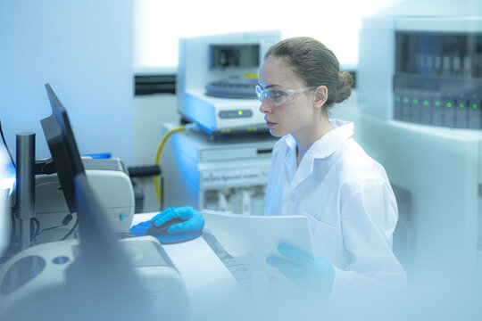 A clinical research associate performs source data verification, comparing patient reports to the electronic data in the Laboratory Information Management System LIMS for a clinical trial.