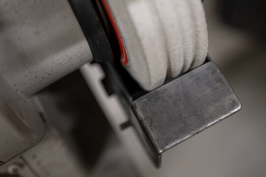 Ground grooves in a white disc on a bench grinder.