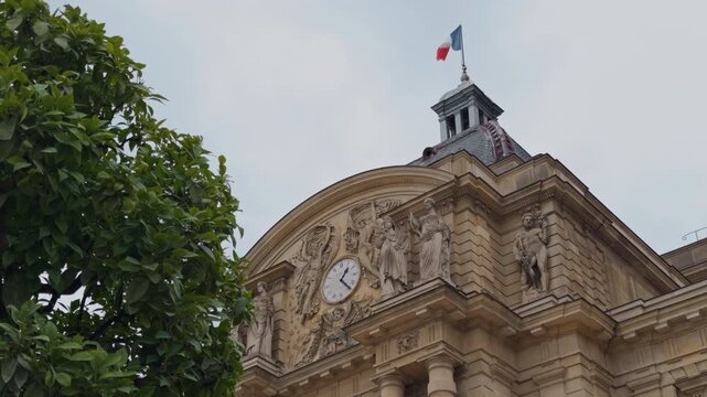 Historical Architecture Featuring a Clock Tower and an Accompanying Flag in a Beautiful Cityscape Setting