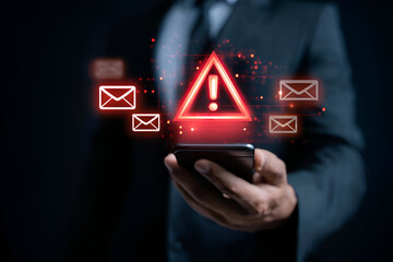 A businessman holding a smartphone with warning alerts about emails, representing digital communication risks.