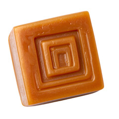 Square caramel candy with embossed concentric squares; isolated against a black background