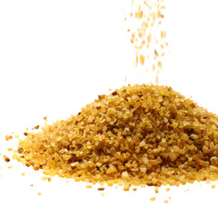 A pile of small, brown grains with some falling from above against a black background