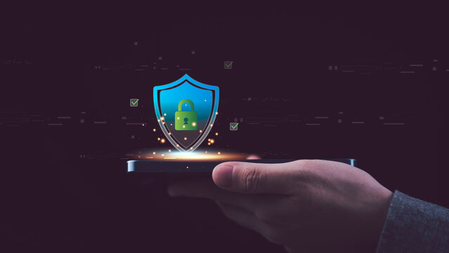 digital shield with padlock icon glowing abovesmartphone, symbolizing cybersecurity, data protection, privacy, and secure online technology systems for safe network communication and cloud storage.