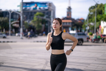 Young woman jogging in city street for fitness