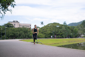 Obraz premium Woman jogging in park, enjoying active outdoor lifestyle