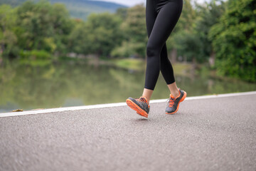 Woman jogging in park practicing healthy lifestyle