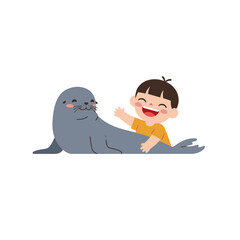 A joyful child interacts playfully with a friendly seal.