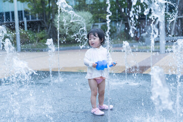 マンション広場の噴水で遊ぶ日本人の幼児