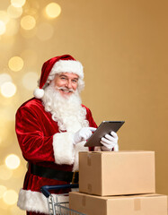 Santa reviews online orders on a tablet beside shipping boxes