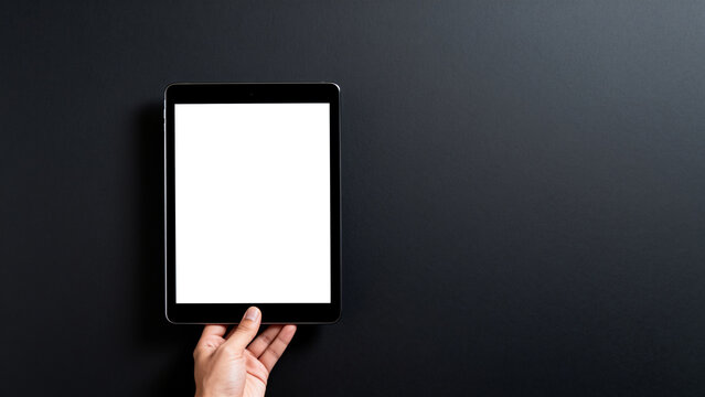 Hand holding tablet with blank screen