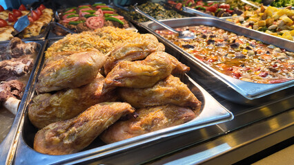 Delicious spread of roasted chicken and sides at a buffet