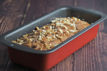 Baked bread topped with nuts cooling in a metal pan