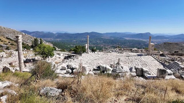 Burdur, Turkey: Panoramic shot of the Upper Agora with Arch of Claudius at distant in Sagalassos, an ancient site in Burdur, Turkey. Filmed from viewpoint at the hill on a sunny day