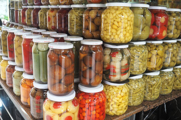 Colorful pickled vegetable jars at the market