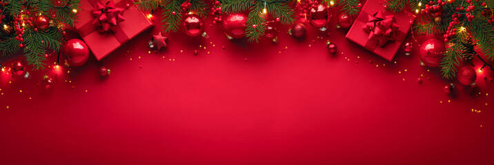 Merry Christmas banner with red gift boxes, tree branches and decorations