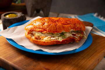 Pambazo. Sandwich marinated in sauce and roasted on a comal traditionally stuffed with potatoes and chorizo, a classic of Mexican street food.