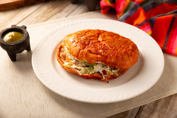 Pambazo. Sandwich marinated in sauce and roasted on a comal traditionally stuffed with potatoes and chorizo, a classic of Mexican street food.