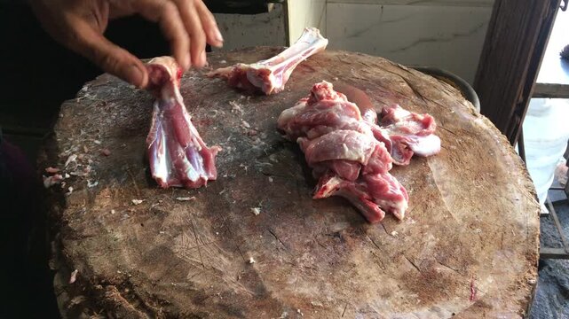 Mutton Shopkeeper Cutting Meat on Wooden Block