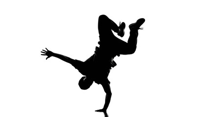 Silhouette of a ballerina in a graceful arabesque pose, leg extended high, arm outstretched.