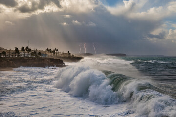 8K ultra-realistic wide photo of hurricane waves crashing against coastal city with sharp water textures and dramatic sky
