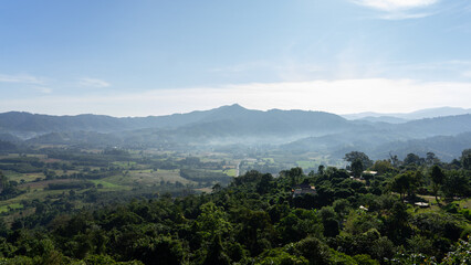 Panoramic Mountain Vista: An expansive mountain scene bathed in sunlight, with rolling hills and a clear sky, a testament to nature's grandeur.