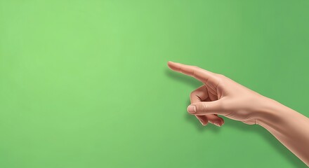 A close-up shot of a human hand pointing towards the left side of a green background.
