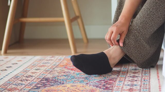 young woman suffering itching skin on her feet 