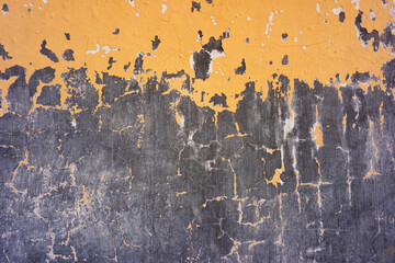 Black wall broken with patches of orange paint