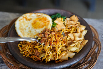 Grilled Chili Noodles, captured on October 8, 2025. Spicy stir-fried noodles charred over flames, topped with fresh herbs and chili, vibrant Indonesian street food scene