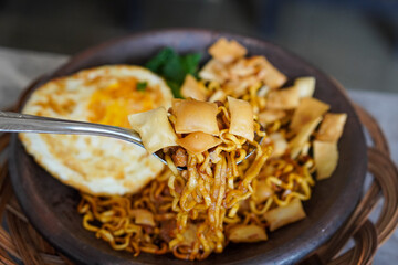 Grilled Chili Noodles, captured on October 8, 2025. Spicy stir-fried noodles charred over flames, topped with fresh herbs and chili, vibrant Indonesian street food scene
