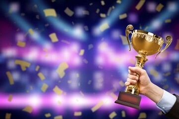 Hand holding golden Trophy cup, Victory concept