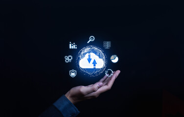 Business hand holding cloud computing icon with data analytics and technology symbols. Concept of digital storage, network connection, cyber security, and online data management in modern business.