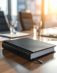 Black Leather Journal on a Wooden Desk in an Office Setting, Professional Notebook with Sunlit Background for Business and Productivity
