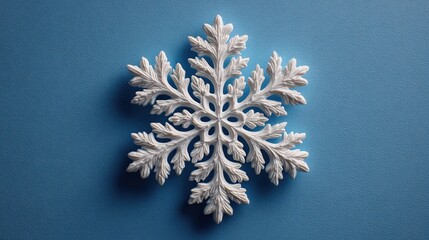Minimal Snowflake on Bright Blue Background. Flat Lay Season Concept.