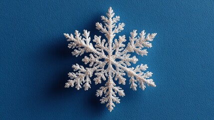 Minimal Snowflake on Bright Blue Background. Flat Lay Season Concept.