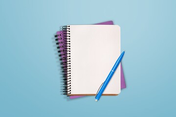 Top view of blank notebook and pen on background