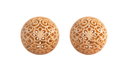 Two intricately carved oval beads isolated on transparent background