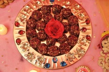 Rose petal laddu or laddo decorated beautifully on a plate with festive background