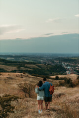 Couple hiking enjoying nature from mountain viewpoint